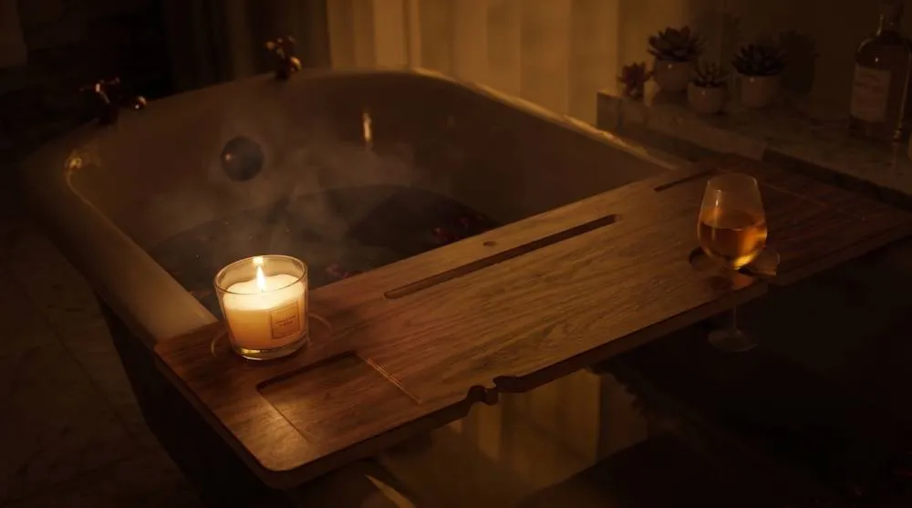 The Waverley Bath Board laid across a steaming freestanding tub by candlelight, a glass of whisky resting in the wine-glass notch.