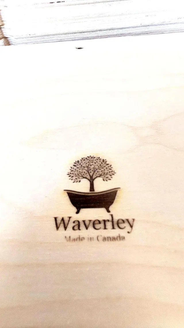The Waverley tree-and-tub mark and the words “Made in Canada” branded into the face of a raw birch board.