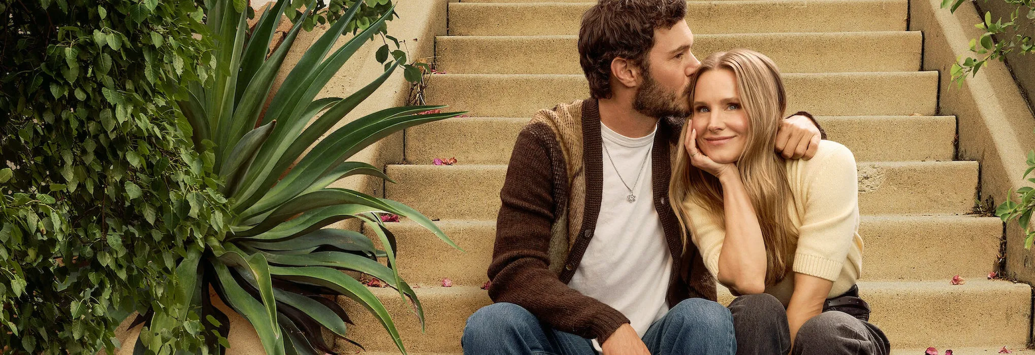 Kristen Bell and Adam Brody sitting together on outdoor steps in Nobody Wants This